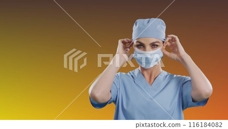 Caucasian nurse wearing blue scrubs, adjusting her mask Caucasian nurse wearing blue scrubs, adjusting her mask 116184082