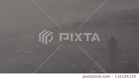 Misty haze enveloping city buildings and hills, creating soft view Misty haze enveloping city buildings and hills, creating soft view 116184139