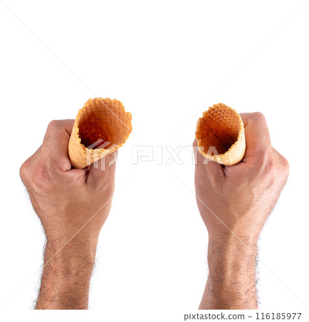 waffle cone on hand isolated over white background. waffle cone on hand isolated over white background. 116185977