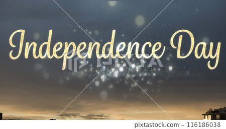 Golden Independence Day text sparkling against twilight sky 116186038
