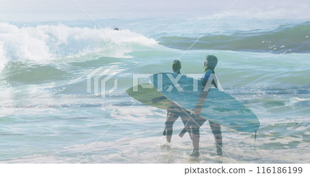 Diverse couple holding surfboards, walking into ocean waves 116186199
