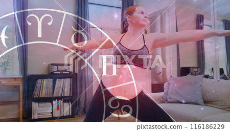A young Caucasian woman, wearing sportswear, practicing yoga at home A young Caucasian woman, wearing sportswear, practicing yoga at home 116186229