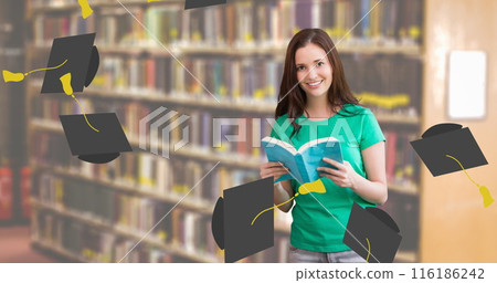 Caucasian student holding book, wearing green t-shirt, smiling in library 116186242