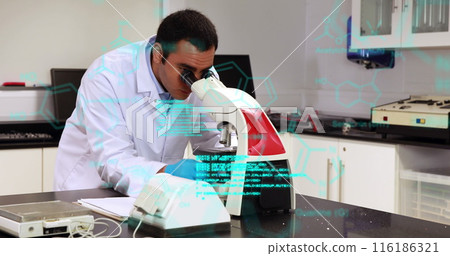 Biracial scientist examining sample under microscope, wearing white lab coat 116186321