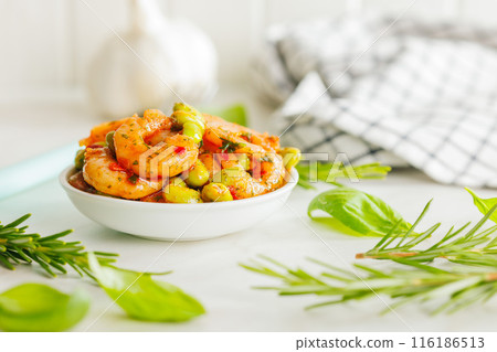Fresh salad with shrimps and edamame soybeans in bowl on white table. 116186513