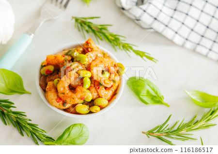 Fresh salad with shrimps and edamame soybeans in bowl on white table. 116186517