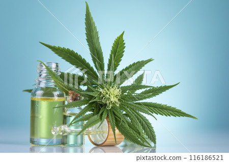 Bottles of cbd oil, marijuana and hemp leaves 116186521