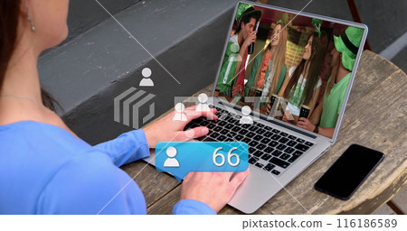 Caucasian female intern wearing blue top, studying a laptop screen 116186589