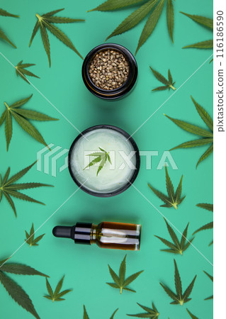 Composition with hemp oil cbd and bottle of oil on green background 116186590