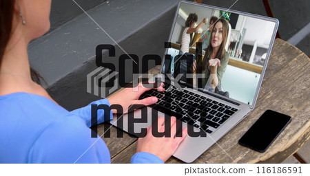 Caucasian professional in blue shirt on laptop displays another on the screen 116186591