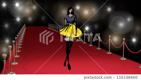 Woman in black and yellow dress walking down red carpet, surrounded by lights 116186660