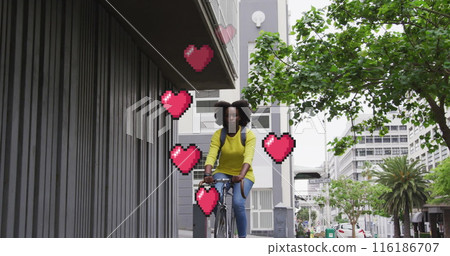 African American girlfriend/wife, wearing yellow top, riding bike in city African American girlfriend/wife, wearing yellow top, riding bike in city 116186707