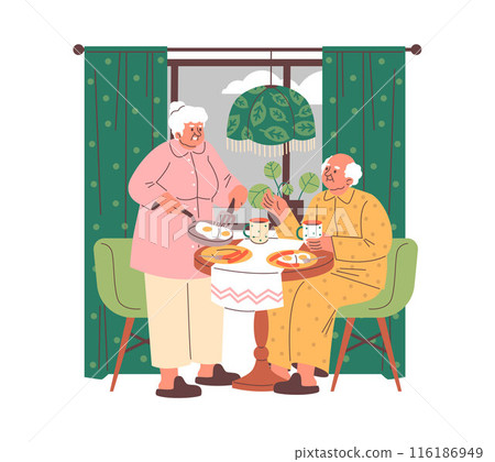 An elderly couple enjoys a scrambled eggs breakfast in the kitchen. 116186949