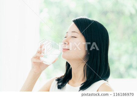A woman drinking water A woman drinking water 116186970