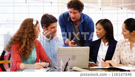 Image of statistical data processing against diverse colleagues discussing over laptop at office 116187846