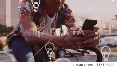 Image of light bulb icons and data processing over african american man using smartphone Image of light bulb icons and data processing over african american man using smartphone 116187988