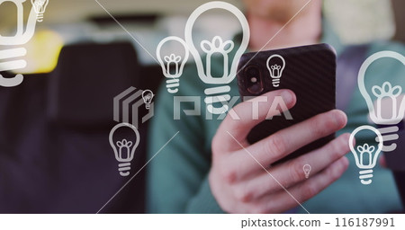 Image of light bulb icons and data processing over african american albino man using smartphone Image of light bulb icons and data processing over african american albino man using smartphone 116187991