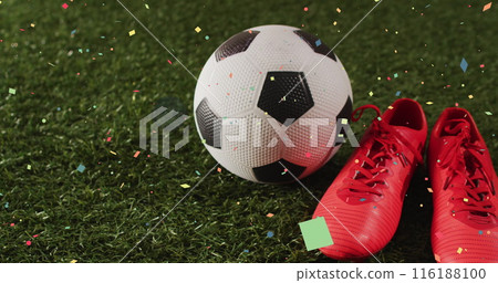 Image of confetti falling over sports shoe and football 116188100