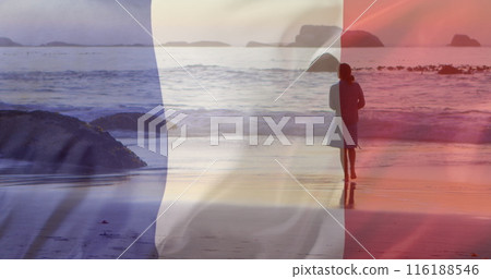 Image of flag of france over caucasian woman walking at beach 116188546