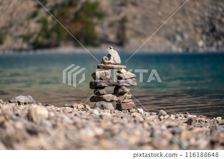 Balancing stones on the shore of the lake. Stack of stones, Pile of rocks, stones tower. Spirit of Zen. 116188648