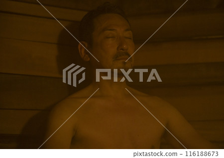 A man in his 50s enjoying the sauna A man in his 50s enjoying the sauna 116188673