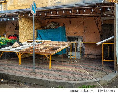Empty stall in the street market. Closed foot in the market. The merchant has finished his work day.  Vegetable stall. 116188865
