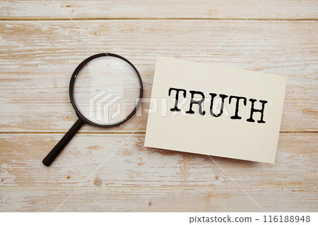 Truth text written on papercard with magnifying glass on wooden background Truth text written on papercard with magnifying glass on wooden background 116188948