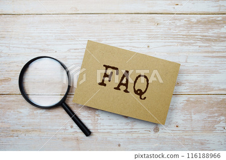 FAQ text message and magnifying glass with space copy on wooden background FAQ text message and magnifying glass with space copy on wooden background 116188966