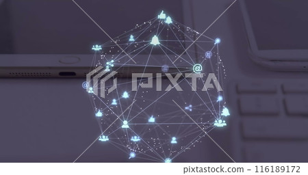 Image of globe of digital icons spinning over close up of laptop, diary and tablet on a table 116189172
