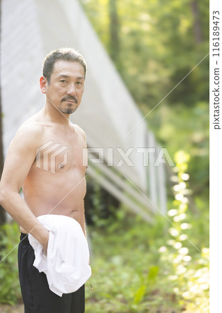 A man in his 50s enjoying the sauna A man in his 50s enjoying the sauna 116189473