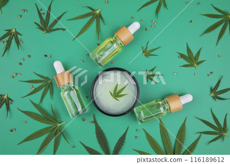Flat lay composition of marijuana and hemp seeds on green color paper background Flat lay composition of marijuana and hemp seeds on green color paper background 116189612