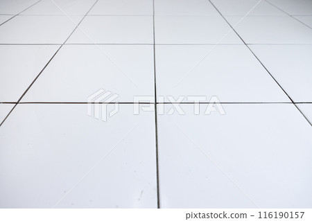 Tile floor under construction in room. 116190157