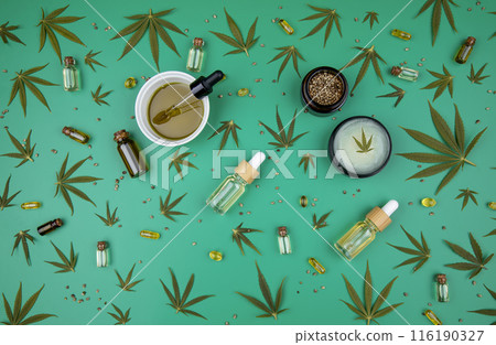 Composition with hemp oil cbd and bottle of oil on green background 116190327