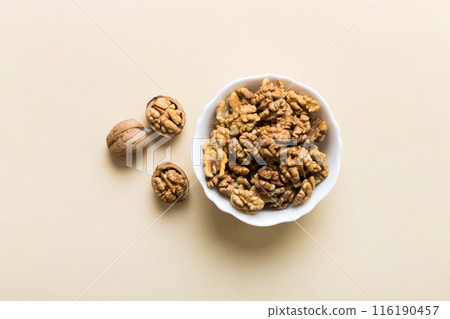 Fresh healthy walnuts in bowl on colored table background. Top view Healthy eating bertholletia concept. Super foods Fresh healthy walnuts in bowl on colored table background. Top view Healthy eating bertholletia concept. Super foods 116190457