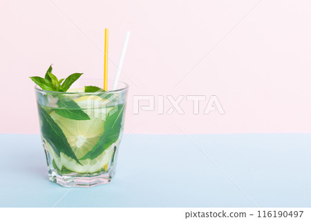 Mojito summer refreshing cocktail with ice and mint. mojito cocktail with lime, lemon and mint in a tall glass with a stick 116190497