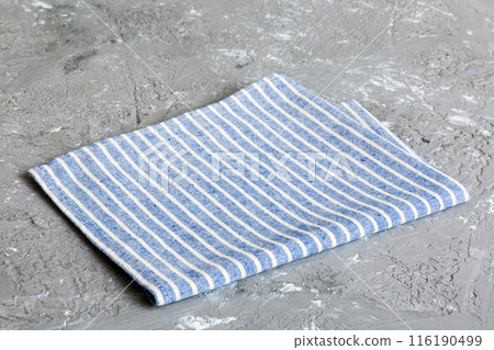 top view with blue kitchen napkin isolated on table background. Folded cloth for mockup with copy space, Flat lay. Minimal style top view with blue kitchen napkin isolated on table background. Folded cloth for mockup with copy space, Flat lay. Minimal style 116190499