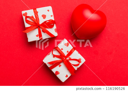 gift box with red bow and red heart on colored background . Top view. Flat lay 116190526