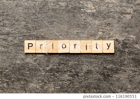 priority word written on wood block. priority text on table, concept 116190551