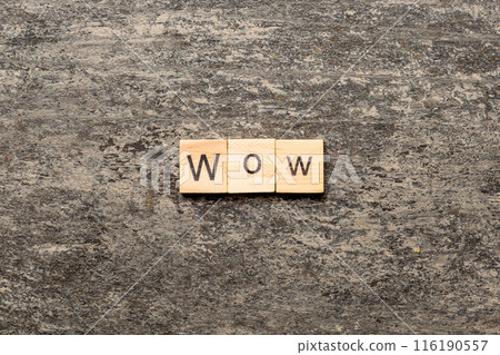 WOW word written on wood block. WOW text on cement table for your desing, concept 116190557