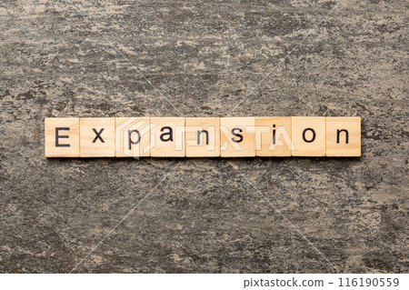 expansion word written on wood block. expansion text on table, concept 116190559