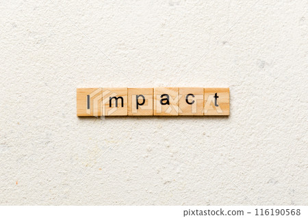 impact word written on wood block. impact text on table, concept impact word written on wood block. impact text on table, concept 116190568