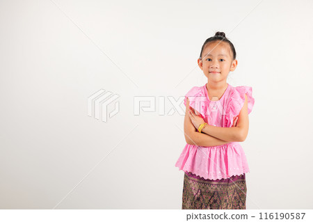 Portrait of Thailand kid girl smiling traditional Thai dress costume with arms crossed in studio shot isolated white background, Happy kindergarten child lifestyle arm folded Portrait of Thailand kid girl smiling traditional Thai dress costume with arms crossed in studio shot isolated white background, Happy kindergarten child lifestyle arm folded 116190587