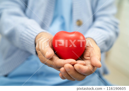 Asian doctor give red heart to elderly woman in her hand, heart Attack. Asian doctor give red heart to elderly woman in her hand, heart Attack. 116190605