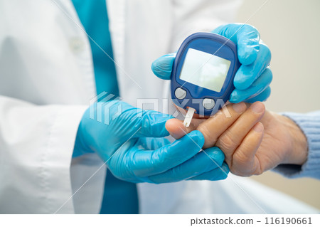 Doctor use digital glucose monitor measure and test stripe for check diabetes from finger blood sugar level. 116190661