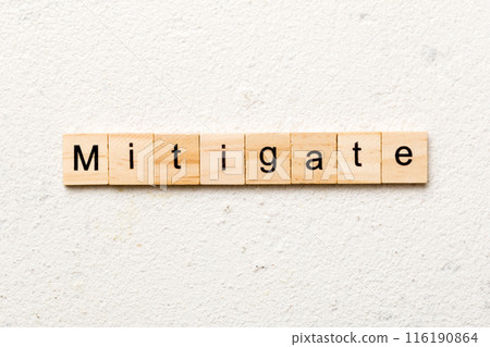 mitigate word written on wood block. mitigate text on table, concept mitigate word written on wood block. mitigate text on table, concept 116190864