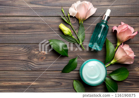 Composition with cosmetic products and beautiful roses on wooden background. Copy space, flat lay 116190875