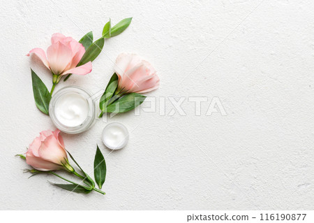 Composition with cosmetic products and beautiful roses on cement background. Copy space, flat lay Composition with cosmetic products and beautiful roses on cement background. Copy space, flat lay 116190877