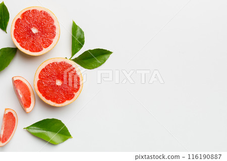 fresh Fruit grapefruit with Juicy grapefruit slices on colored background. Top view. Copy Space. creative summer concept. Half of citrus in minimal flat lay with copy space fresh Fruit grapefruit with Juicy grapefruit slices on colored background. Top view. Copy Space. creative summer concept. Half of citrus in minimal flat lay with copy space 116190887