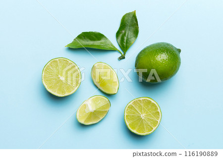 Lime fruits with green leaf and cut in half slice isolated on white background. Top view. Flat lay with copy space Lime fruits with green leaf and cut in half slice isolated on white background. Top view. Flat lay with copy space 116190889
