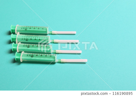 Top view of different syringes for injection on colorful background. Medical equipment concept with copy space 116190895